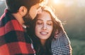 Young beautiful couple with checkered plaid walking outside on beautiful sunset. Perfect romantic landscape for lovestory. Two Royalty Free Stock Photo