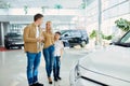 Young beautiful couple with child choosing their first auto Royalty Free Stock Photo