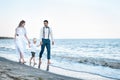 Young beautiful couple with child walking on the beach. Happy family concept Royalty Free Stock Photo