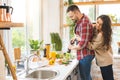 Young beautiful couple cooking together in their kitchen at home Royalty Free Stock Photo