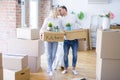 Young beautiful couple with dog moving cardboard boxes at new home Royalty Free Stock Photo