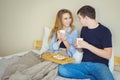 Young beautiful couple drinking coffee in bed at morning Royalty Free Stock Photo