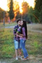 Young beautiful couple embracing and smiling at sunset in summer Royalty Free Stock Photo