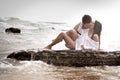 Young beautiful couple flirting and kissing at the beach Royalty Free Stock Photo