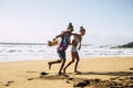 Young beautiful couple have fun and laugh at the beach in summer holiday vacation - people and travel lifestyle enjoy the sand and Royalty Free Stock Photo