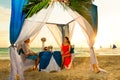 Young beautiful couple have a romantic dinner at sunset on a tropical beach . Honeymoon. Royalty Free Stock Photo