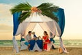 Young beautiful couple have a romantic dinner at sunset on a tropical beach . Honeymoon. Royalty Free Stock Photo