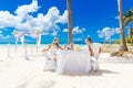 Young beautiful couple have a romantic dinner on a tropical beach . Wedding ceremony on a tropical beach. Wedding and honeymoon c Royalty Free Stock Photo