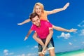 Young beautiful couple having fun on a tropical beach. Royalty Free Stock Photo