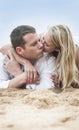 Young beautiful couple kissing on beach sand Royalty Free Stock Photo