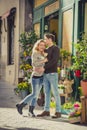 Young beautiful couple in love kissing on street celebrating Valentines day with rose gift Royalty Free Stock Photo