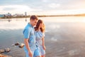 Young beautiful couple in love staying and kissing on the beach on sunset. Soft sunny colors. Royalty Free Stock Photo