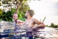 Young beautiful couple man and woman have fun in the outdoor poo Royalty Free Stock Photo