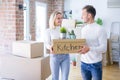 Young beautiful couple moving cardboard boxes at new home Royalty Free Stock Photo