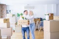 Young beautiful couple moving cardboard boxes at new home Royalty Free Stock Photo