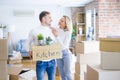 Young beautiful couple moving cardboard boxes at new home Royalty Free Stock Photo