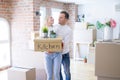 Young beautiful couple moving cardboard boxes at new home Royalty Free Stock Photo