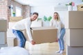 Young beautiful couple moving cardboard boxes at new home Royalty Free Stock Photo