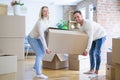 Young beautiful couple moving cardboard boxes at new home Royalty Free Stock Photo