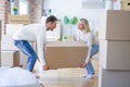Young beautiful couple moving cardboard boxes at new home Royalty Free Stock Photo