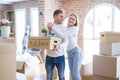 Young beautiful couple moving cardboard boxes at new home Royalty Free Stock Photo