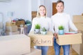 Young beautiful couple moving cardboard boxes at new home Royalty Free Stock Photo