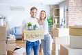 Young beautiful couple moving cardboard boxes at new home Royalty Free Stock Photo