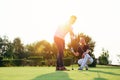Young couple playing golf. Personal trainer giving lesson on golf course. Royalty Free Stock Photo