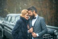 Young beautiful couple relaxing together walking at a retro car. Vintage people. Royalty Free Stock Photo