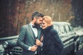 Young beautiful couple relaxing together walking at a retro car. Royalty Free Stock Photo