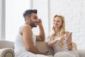 Young Beautiful Couple Sit On Coach Near Window, Using Cell Smart Phone Happy Smile Hispanic Man Woman Royalty Free Stock Photo