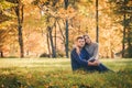 Young beautiful couple is sitting on the meadow Royalty Free Stock Photo
