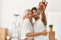 Young beautiful couple smiling happy holding key of new home Royalty Free Stock Photo