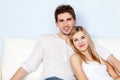 Young beautiful couple on a sofa at home Royalty Free Stock Photo