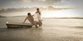 Young beautiful couple spending afternoon on beach with old bath tub