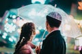 Young beautiful couple spending time together on date in amusement park at night. Rainy weather, autumn. Lovers standing Royalty Free Stock Photo