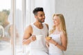 Young Beautiful Couple Stand Near Big Window, Drink Morning Coffee Cup, Happy Smile Hispanic Man And Woman Royalty Free Stock Photo