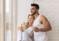 Young Beautiful Couple Stand Near Big Window, Drink Morning Coffee Cup, Happy Smile Hispanic Man Woman Royalty Free Stock Photo