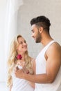 Young Beautiful Couple Stand Near Big Window, Hispanic Man Give Woman Red Rose Royalty Free Stock Photo