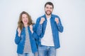 Young beautiful couple standing together over white isolated background excited for success with arms raised and eyes closed Royalty Free Stock Photo