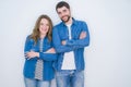 Young beautiful couple standing together over white isolated background happy face smiling with crossed arms looking at the camera Royalty Free Stock Photo