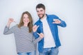 Young beautiful couple standing together over white isolated background looking confident with smile on face, pointing oneself Royalty Free Stock Photo