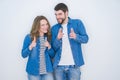 Young beautiful couple standing together over white isolated background pointing fingers to camera with happy and funny face Royalty Free Stock Photo