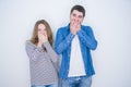 Young beautiful couple standing together over white isolated background shocked covering mouth with hands for mistake Royalty Free Stock Photo