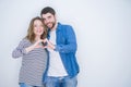 Young beautiful couple standing together over white isolated background smiling in love showing heart symbol and shape with hands Royalty Free Stock Photo