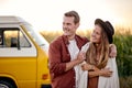 Young beautiful couple take a break during trip, stopped near cornfield, enjoy