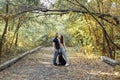 A young beautiful couple and their labrador are walking in the Park. Man, woman and dog. Warm autumn evening in the forest Royalty Free Stock Photo