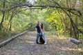 A young beautiful couple and their labrador are walking in the Park. Man, woman and dog. Warm autumn evening in the forest Royalty Free Stock Photo