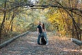 A young beautiful couple and their labrador are walking in the Park. Man, woman and dog. Warm autumn evening in the forest Royalty Free Stock Photo
