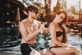 Young Beautiful Couple using Sunscreen at Poolside Royalty Free Stock Photo